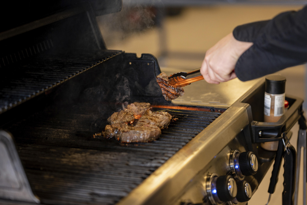 close-up-hand-cooking-delicious-meat.jpg